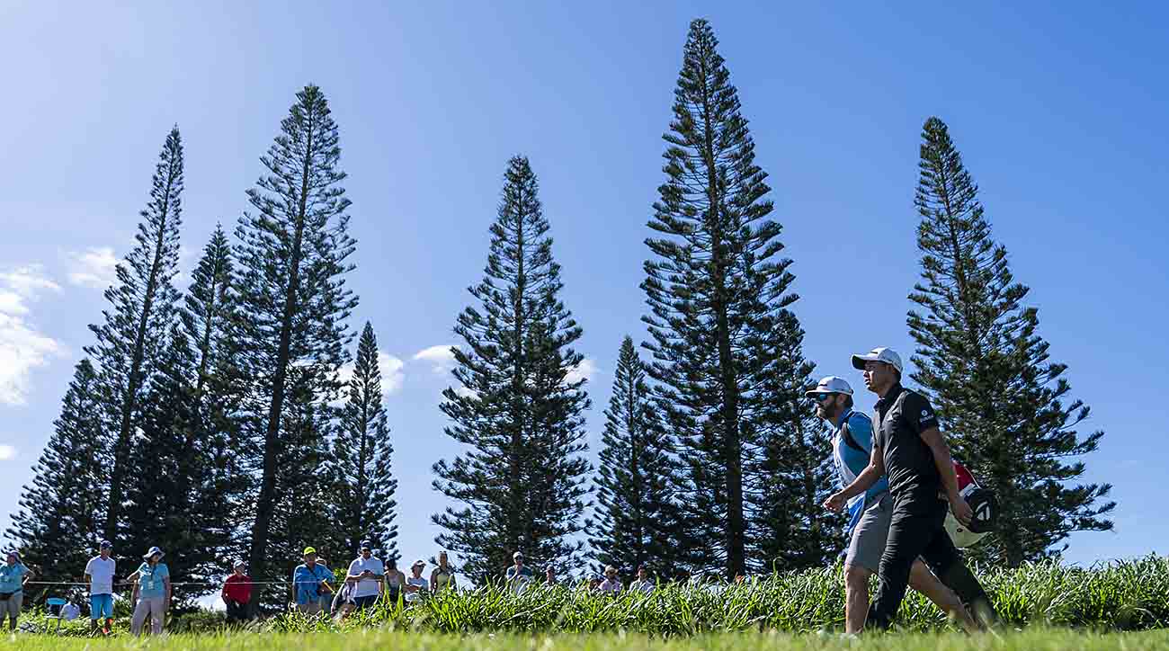 Collin Morikawa and his caddie walk on the third hole during the final round of the 2023 Sentry Tournament of Champions at Kapalua Resort in Hawai‘i.